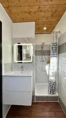a white bathroom with a sink and a shower at Lion's Room - 2 minute walk from Palais des Festivals and Beaches in Cannes