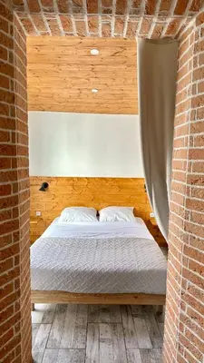 a bedroom with a bed in a brick wall at Lion's Room - 2 minute walk from Palais des Festivals and Beaches in Cannes