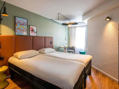 a bedroom with a bed and a blue wall at ibis Cannes Centre in Cannes