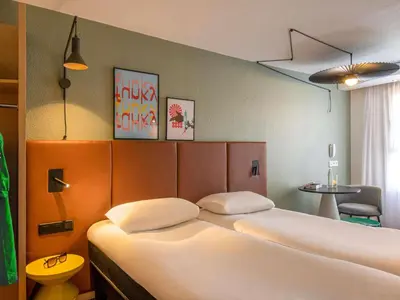 a room with a bedroom with a bed and a closet at ibis Cannes Centre in Cannes