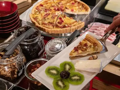 a bakery with red cabinets and a counter with food at ibis Cannes Centre in Cannes