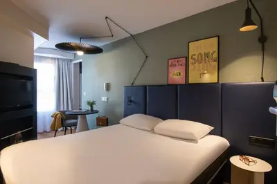 a pool table in a room with two tables and a pool table at ibis Cannes Centre in Cannes