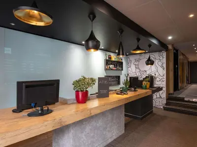 a dining room with a table and four chairs at ibis Cannes Centre in Cannes