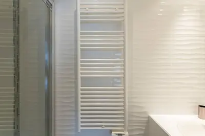 a bathroom with white walls and a shower with white shelving at MARTINEZ HOTEL AREA: Modern 3 bedrooms w/ terrace in Cannes