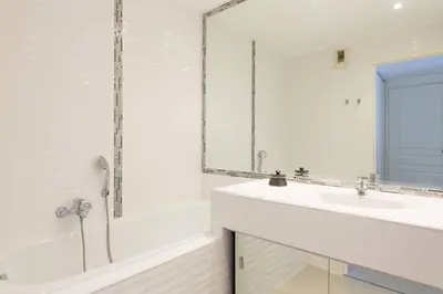 a white bathroom with a sink and a shower at MARTINEZ HOTEL AREA: Modern 3 bedrooms w/ terrace in Cannes