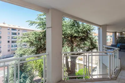 a balcony with a view of a tree at MARTINEZ HOTEL AREA: Modern 3 bedrooms w/ terrace in Cannes