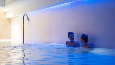 two young girls in a swimming pool at Hôtel Montaigne & Spa - Cannes Centre in Cannes