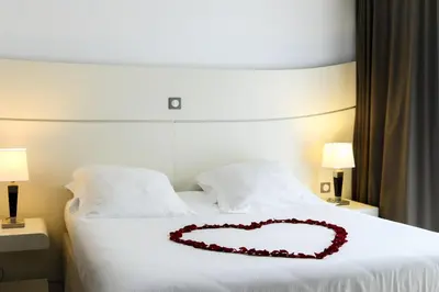 a heart pillow on a bed in a hotel room at Hôtel Montaigne & Spa - Cannes Centre in Cannes