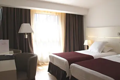 a hotel room with a bed and a window at Hôtel Montaigne & Spa - Cannes Centre in Cannes