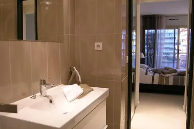 a bathroom with a sink and a mirror at Modern two bedroom apartment with two bathrooms, just behind the CARLTON in Cannes