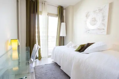 a white bedroom with a glass table and a bed at Modern two bedroom apartment with two bathrooms, just behind the CARLTON in Cannes