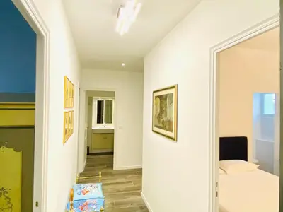 a bedroom with white walls and a bed and a mirror at Cozy 2 bedroom apartment in the centre of Cannes near the CROISETTE in Cannes