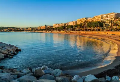 a view of a beach with rocks and buildings at Cozy 2 bedroom apartment in the centre of Cannes near the CROISETTE in Cannes