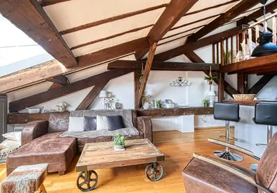 a living room with a couch and a table at LE BOISE merveilleux duplex rustique, excellent emplacement à quelques pas du Palais in Cannes