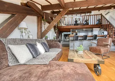 a living room with a couch and a table at LE BOISE merveilleux duplex rustique, excellent emplacement à quelques pas du Palais in Cannes