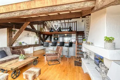 a living room with a couch and a table at LE BOISE merveilleux duplex rustique, excellent emplacement à quelques pas du Palais in Cannes