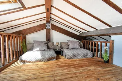 a room with two beds on a wooden deck at LE BOISE merveilleux duplex rustique, excellent emplacement à quelques pas du Palais in Cannes