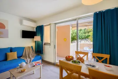 a living room with a blue couch and a table at Résidence Villa Livia in Cannes