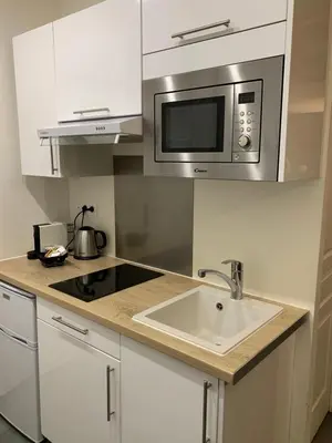 a kitchen with a sink and a microwave at Relaxhome - Hypercentre - Clim - Netflix in Cannes