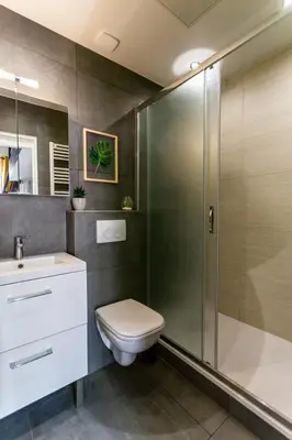 a bathroom with a shower and a toilet and a sink at Relaxhome - Hypercentre - Clim - Netflix in Cannes