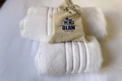 a stack of towels with a bag on top at Cannes Carré d'Or Cozy 1 BR balcony, Croisette Palais 2 mn by Olam Properties in Cannes