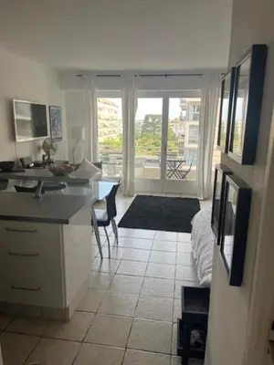 a kitchen with a counter and a kitchen with a table at Trianon Palace in Cannes