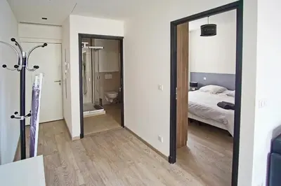 a bedroom with a bed and a large mirror at Cosy 1BR Cannes Gambetta hyper centre - Croisette 1 mn - 4 pers by Olam Properties in Cannes