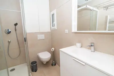 a bathroom with a shower and a toilet and a sink at Cosy 1BR Cannes Gambetta hyper centre - Croisette 1 mn - 4 pers by Olam Properties in Cannes
