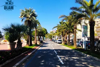 a street with palm trees on the sides of the road at Cosy 1BR Cannes Gambetta hyper centre - Croisette 1 mn - 4 pers by Olam Properties in Cannes