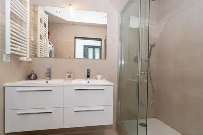 a bathroom with a white sink and a shower at Brand new 2 BR Gambetta Fully Renovated 2021- 5 mns Palais by Olam Properties in Cannes