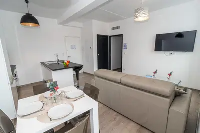 a living room with a couch and a table at Brand new 2 BR Gambetta Fully Renovated 2021- 5 mns Palais by Olam Properties in Cannes