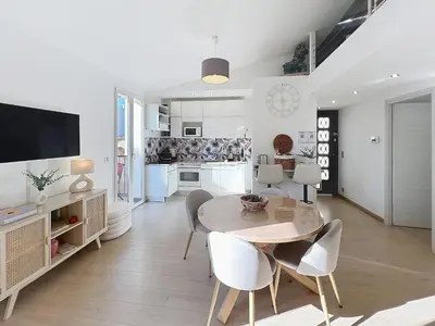 a kitchen and dining room with a table and chairs at Cannes Close Centre 2 BR 2 bath mezzanine & balconies Exceptional Rating Ideal Families Easy parking by Olam Properties in Cannes