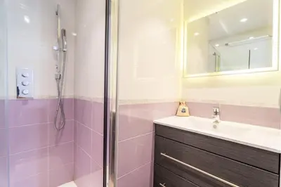 a bathroom with a sink and a shower at Cannes Close Centre 2 BR 2 bath mezzanine & balconies Exceptional Rating Ideal Families Easy parking by Olam Properties in Cannes