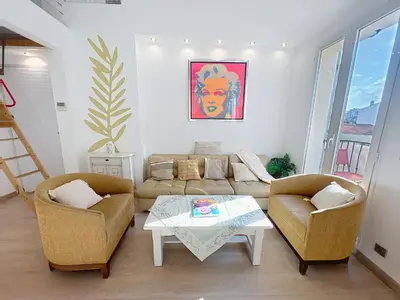 a living room with a couch and two chairs and a table at Cannes Close Centre 2 BR 2 bath mezzanine & balconies Exceptional Rating Ideal Families Easy parking by Olam Properties in Cannes