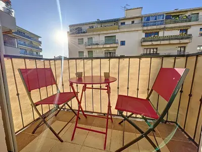 two chairs and a table on a balcony at Cannes Close Centre 2 BR 2 bath mezzanine & balconies Exceptional Rating Ideal Families Easy parking by Olam Properties in Cannes
