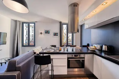 a kitchen with a counter and a kitchen island in a room at Heart of Cannes Amazing design apartment Croisette Top Location Best Seller by OIam Properties in Cannes