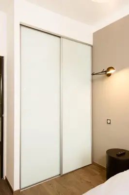 two sliding doors in a bedroom with a lamp at Heart of Cannes Amazing design apartment Croisette Top Location Best Seller by OIam Properties in Cannes
