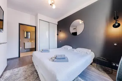 a bedroom with a large white bed with towels on it at Heart of Cannes Amazing design apartment Croisette Top Location Best Seller by OIam Properties in Cannes