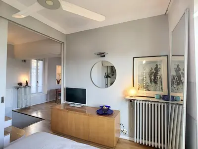 a living room with a tv and a mirror at FRGK 