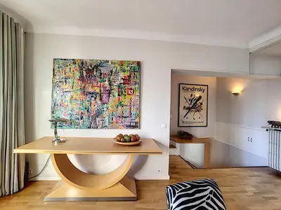 a table in a room with a painting on the wall at FRGK 