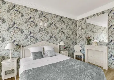 a bedroom with a bed and a chair and a window at Croisette Palais Miramar Cannes Imperial in Cannes