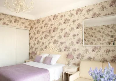 a living room with a tv and floral wallpaper at Croisette Palais Miramar Cannes Imperial in Cannes