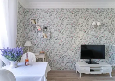 a shelf with books on a wall with flowers at Croisette Palais Miramar Cannes Imperial in Cannes