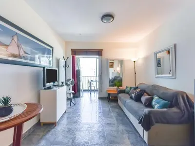 a living room with a couch and a tv at Apartment La Brise by Interhome in Cannes