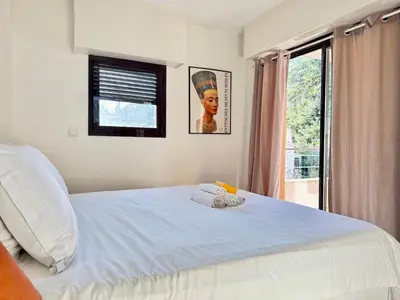 a bedroom with a bed with two towels on it at Spacious Luxury apt, 12 min walk to Croisette beach and Conf Centre in Cannes