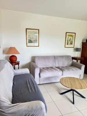 a living room with a couch and a table at Spacious Luxury apt, 12 min walk to Croisette beach and Conf Centre in Cannes