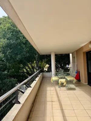 a patio with a table and chairs on a balcony at Spacious Luxury apt, 12 min walk to Croisette beach and Conf Centre in Cannes