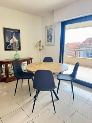 a dining room with a table and four chairs at Spacious Luxury apt, 12 min walk to Croisette beach and Conf Centre in Cannes