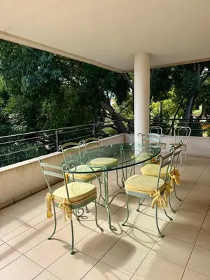 a glass table and chairs on a balcony at Spacious Luxury apt, 12 min walk to Croisette beach and Conf Centre in Cannes