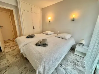 a bedroom with a bed with shoes on it at Branly 2, by Welcome to Cannes in Cannes